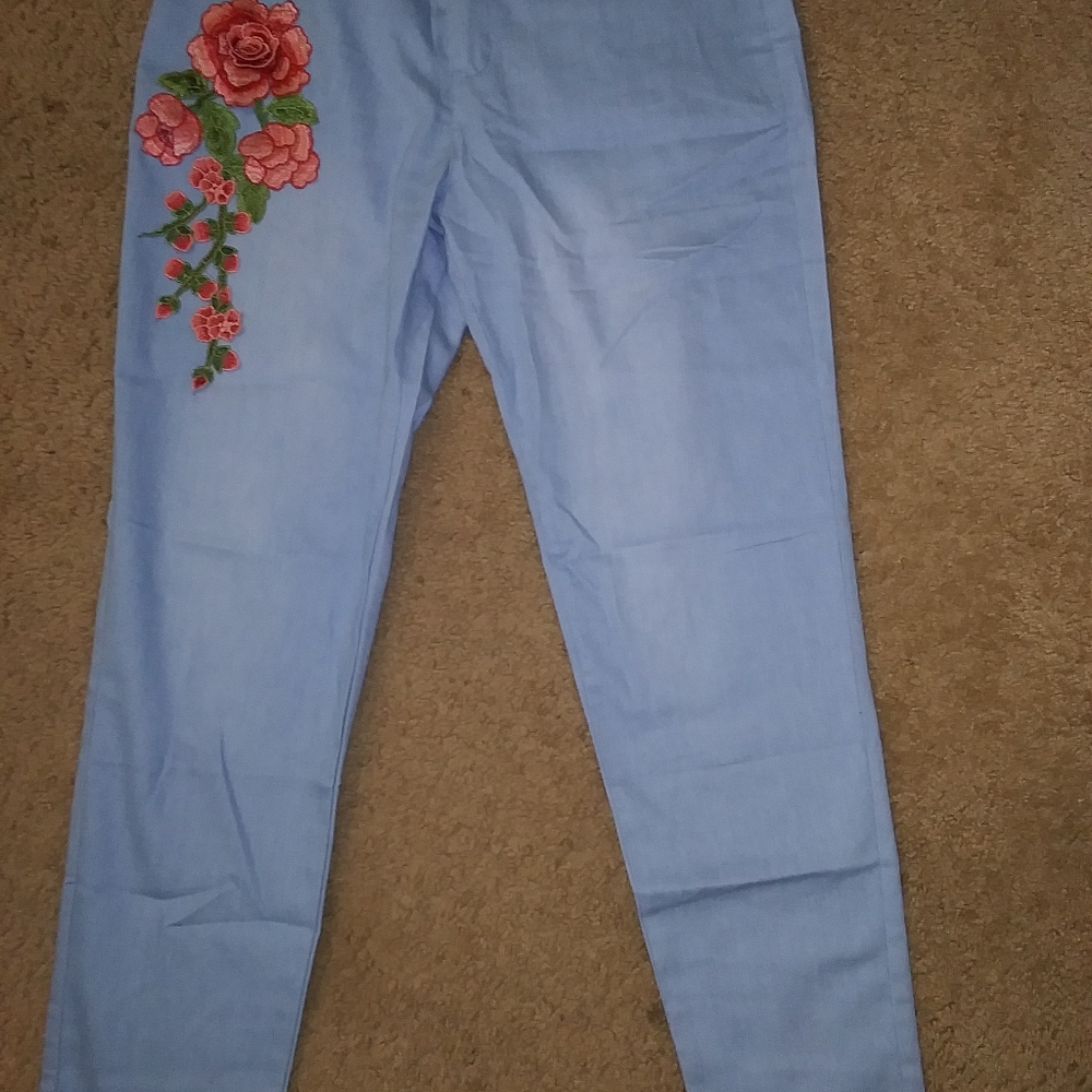 Size medium woman's light blue skinny jean leggings with rose embroidery